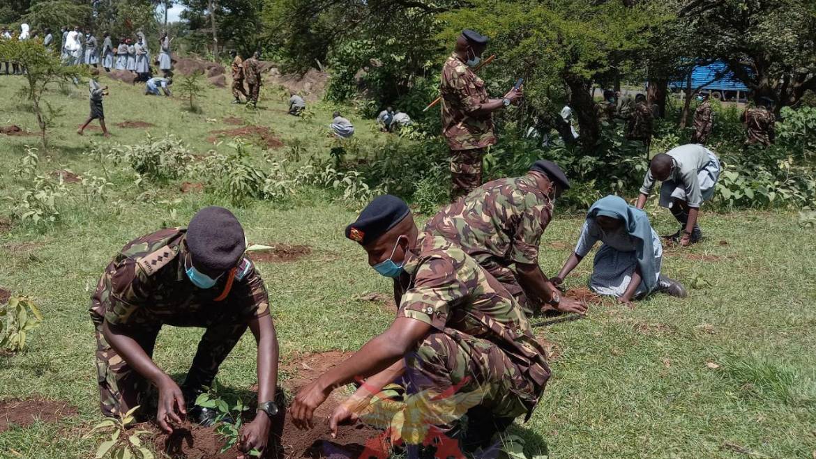 9TH BATALION SOLDIERS TOGETHER WITH MOI BARRACKS SCHOOL PUPILS PLANT TREES TO CONSERVE ENVIRONMENT