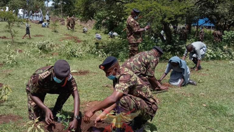 9TH BATALION SOLDIERS TOGETHER WITH MOI BARRACKS SCHOOL PUPILS PLANT TREES TO CONSERVE ENVIRONMENT